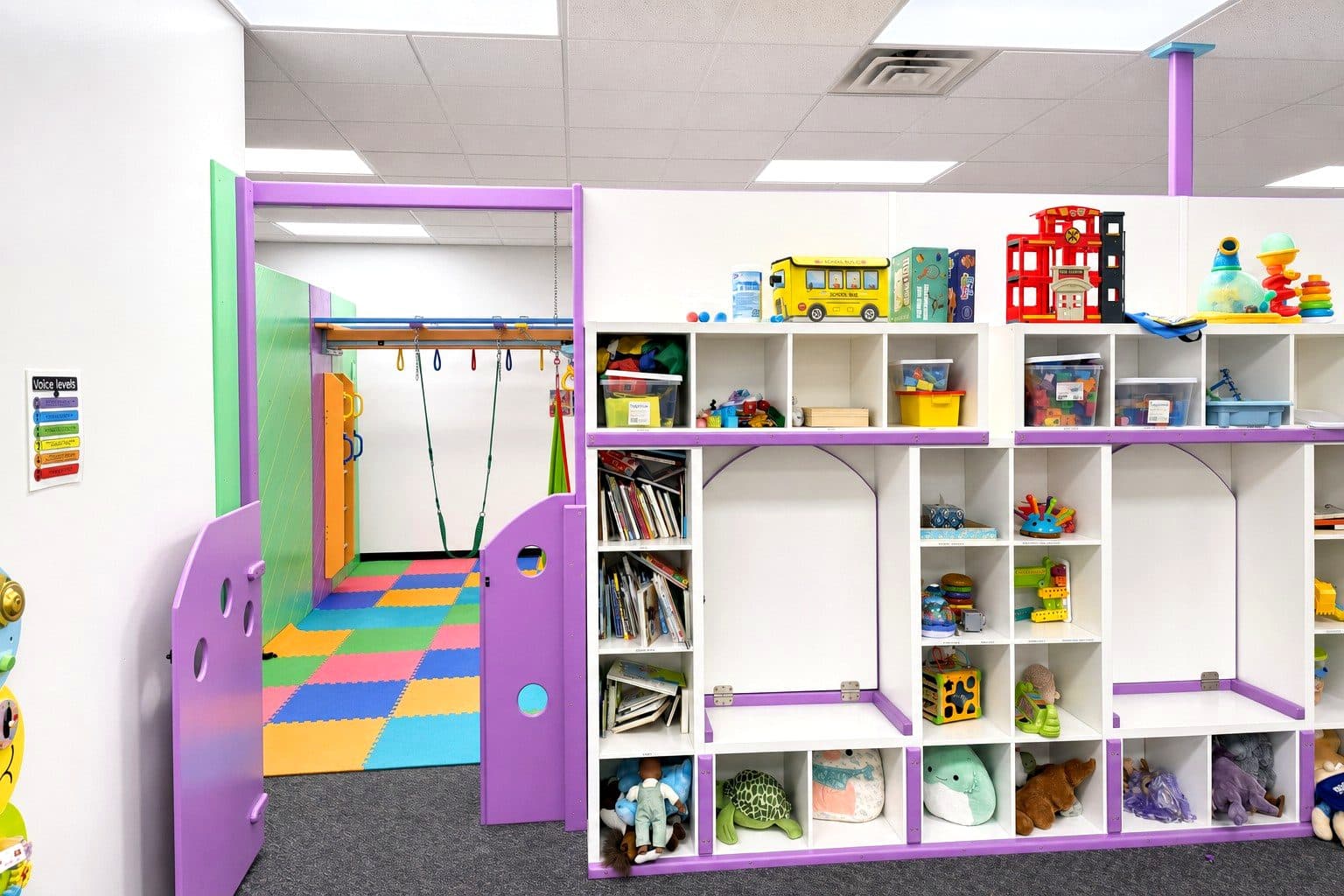 A playroom at our Eagan clinic with a swing frame and colorful floor tiles