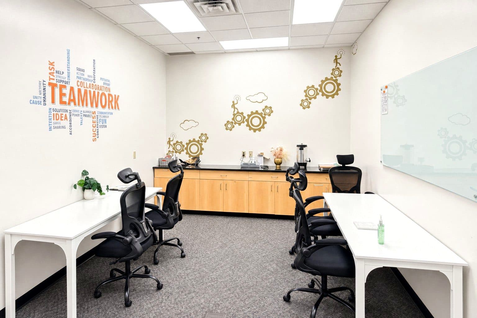 The staff work room at our Eagan clinic with shared desks and a TEAMWORK mural