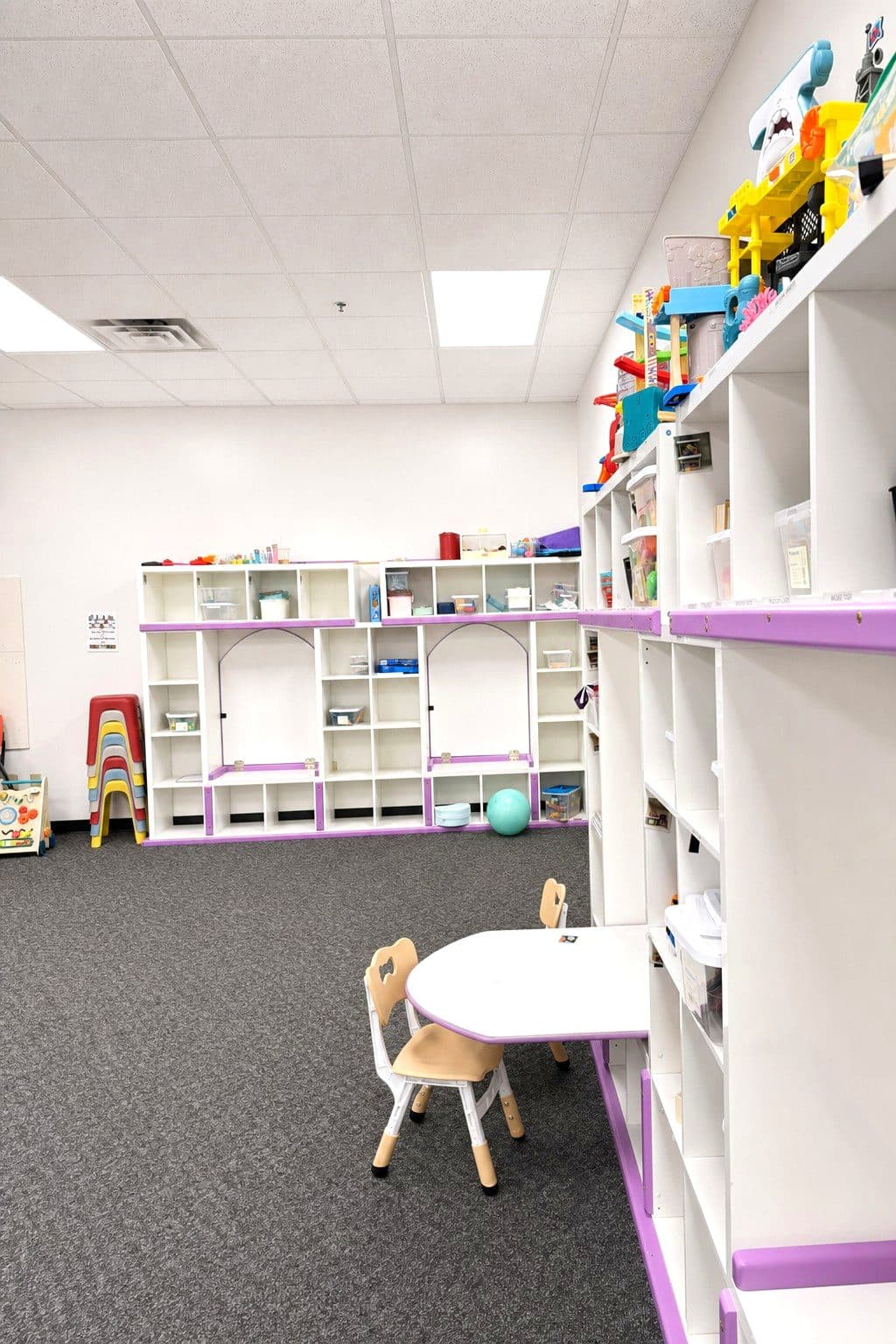A therapy room at our Eagan clinic with a child-height table and chair set up for desk work