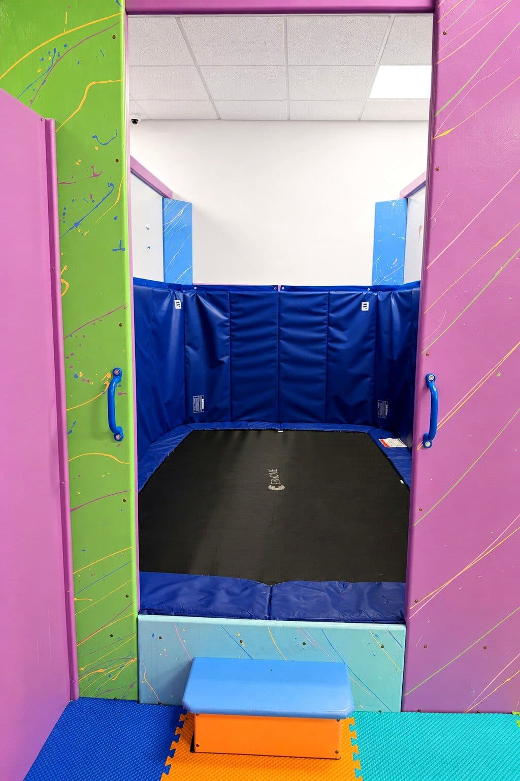 The trampoline and climbing wall in the sensory gym at our Eagan clinic